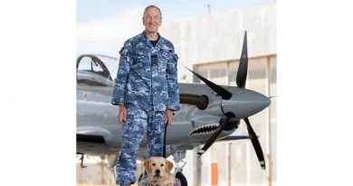 Group Captain Andrew Figtree, Director - Test and Evaluation Directorate with trainee guide dog 'Roman', on the Aircraft Research and Development Unit flight line, at RAAF Base Edinburgh. Story by Leading Aircraftwoman Jasna McFeeters. Photo by Leading Aircraftman Stewart Gould.