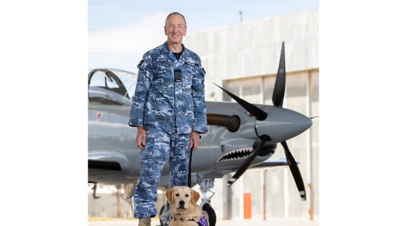 Group Captain Andrew Figtree, Director - Test and Evaluation Directorate with trainee guide dog 'Roman', on the Aircraft Research and Development Unit flight line, at RAAF Base Edinburgh. Story by Leading Aircraftwoman Jasna McFeeters. Photo by Leading Aircraftman Stewart Gould.