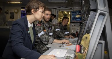 Able Seaman Hamish Scott demonstrates HMAS Sydney's marine technical console to Madeleine Devitt during the Indo Pacific 2022 conference in Sydney. Story by Lieutenant Yvette Goldberg. Photo by Leading Seaman Matthew Lyall.