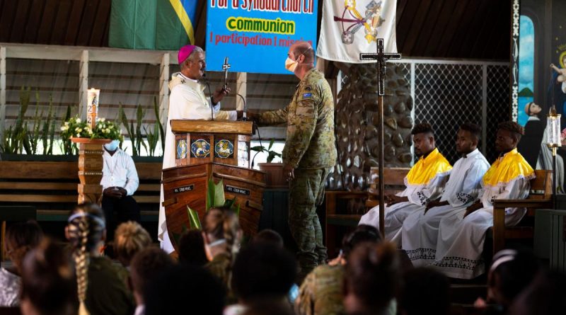 Australian Army padre Chaplain Haydn Parsons is presented a farewell gift by Archbishop Christopher Cardone during a service at Holy Cross Cathedral in Honiara, Solomon Islands. Story and photo by Corporal Julia Whitwell.