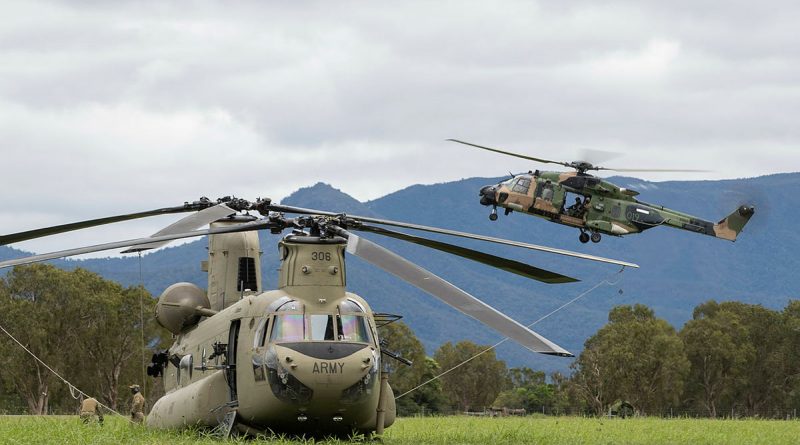 Australian Army MRH90 Taipan from the 5th Aviation Regiment prepares to land behind the CH-47F Chinook during Exercise Vigilant Scimitar at Ingham Airport, Queensland. Story by Captain Carolyn Barnett. Photo by Corporal Jarrod McAneney.