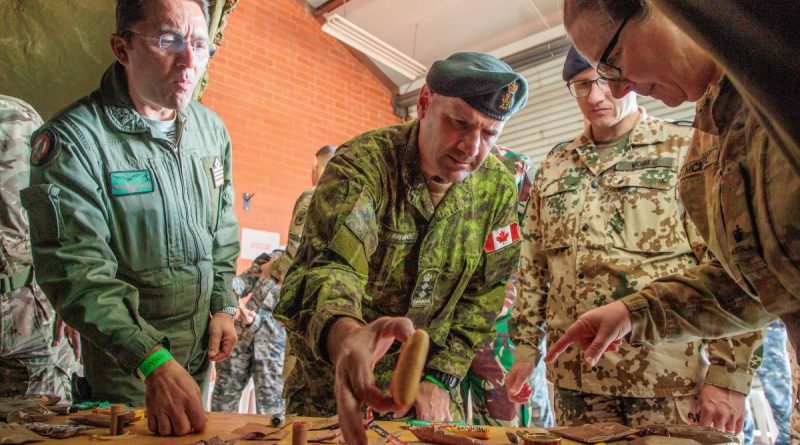 (L-R) Italian Air Force Defence Attaché Colonel Salvatore Trincone, Canadian Defence Attaché Colonel Richard Raymond, and German Deputy Defence Attaché Lieutenant Colonel (GS) Dominic Vogel, try food at HMAS Stirling. Story by Kristi Cheng. Photo by Corporal Robert Whitmore.