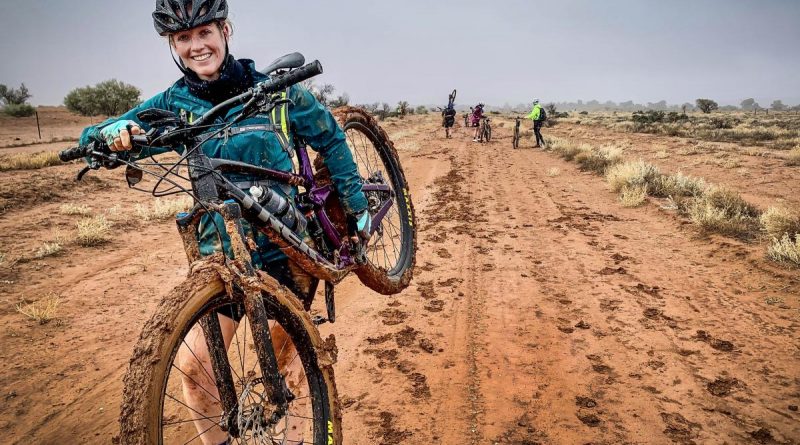 Flying Officer Kaylee Verrier carries her bike through some muddy terrain during the adventure-networking expedition. Story and photo by Corporal Melina Young.