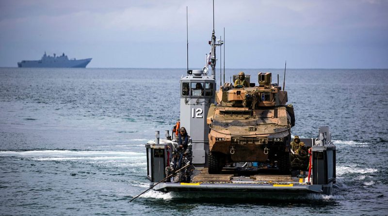 An Australian Army Boxer Combat Reconnaissance Vehicle from the 2nd/14th Light Horse Regiment prepares to disembark from one of HMAS Adelaide's Landing Craft near Cowley Beach Training Area, during Exercise Sea Explorer 2022. Story by Captain Joanne Leca. Photo by Corporal Cameron Pegg.