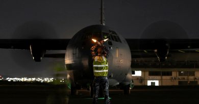 Aircraftman Sam Schmidt, from the No. 382 Squadron, marshals a C-130J from RAAF Base Richmond at the Air Movements Wing – Port Moresby. Story by Major Martin Hadley. Photo by Corporal Jonathan Geodhart.