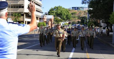 The band of the 1st Battalion, Royal Australian Regiment, led by Lieutenant Colonel Daniel Hiscock, is challenged by a Queensland policeman during the parade in Townsville. Story by Sergeant Matthew Bicker ton. Photo by Sergeant James Duquemin.