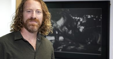 Retired Australian Army officer and artist Mike Armstrong stands in front of a photograph he produced as part of a photographic exhibition titled 'Voices of Veterans' at the National Press Gallery in Canberra. Story by Sergeant Matthew Bickerton.