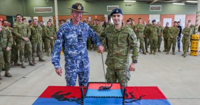 Combat Support Group's Commander, Air Commodore David Paddison, CSC and No. 3 Security Forces Squadron's most junior member, Aircraftman Aidan Tocci, cut the cake to celebrate the squadron's 20th birthday. Story by Leading Aircraftwoman Jasna McFeeters. Photo by Corporal Brenton Kwaterski.