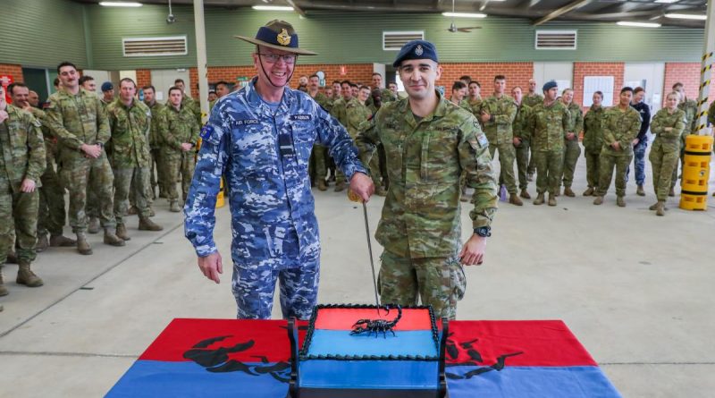 Combat Support Group's Commander, Air Commodore David Paddison, CSC and No. 3 Security Forces Squadron's most junior member, Aircraftman Aidan Tocci, cut the cake to celebrate the squadron's 20th birthday. Story by Leading Aircraftwoman Jasna McFeeters. Photo by Corporal Brenton Kwaterski.