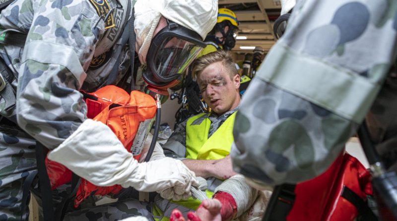 Navy personnel act as first responders during a simulated emergency on board HMAS Choules berthed at Fleet Base East in Sydney. Story by Lieutenant Max Logan. Photo by Able Seaman Benjamin Ricketts.
