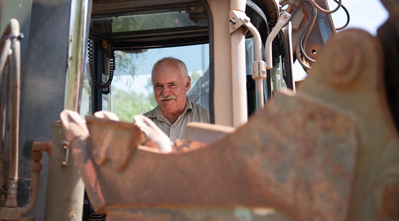 Plant foreman Corporal Greg McKenzie from 6th Engineer Support Regiment brings a backhoe onto site during Army Aboriginal Community Assistance Program 2022 at Gapuwiyak in the Northern Territory. Photo by Corporal Petersen.