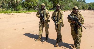 Norforce Darwin Squadron soldiers, Private Peter Puruntatameri, left, Private Blake Carter and Private Misman Kris on a beach in Melville Island during a community engagement visit to the Tiwi Islands. Story by Lieutenant Geoff Long. Photo by Leading Seaman Nadav Harel.