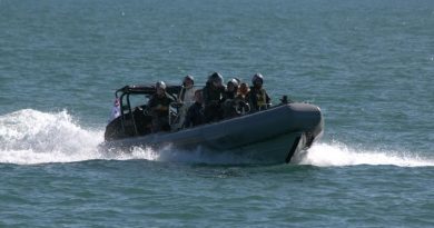 Personnel from HMAS Maryborough transport three rescued civilians in a rigid hull inflatable boat off Darwin, Northern Territory. Story by Lieutenant Max Logan.
