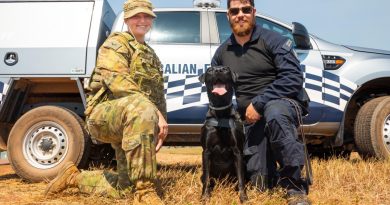 Royal Australian Air Force military working dog handler Leading Aircraftwoman Taylah Cole greets an Australian Federal Police working dog and her handler at RAAF Base Darwin. Story by Flight Lieutenant Dee Irwin. Photo by Leading Aircraftman Sam Price.