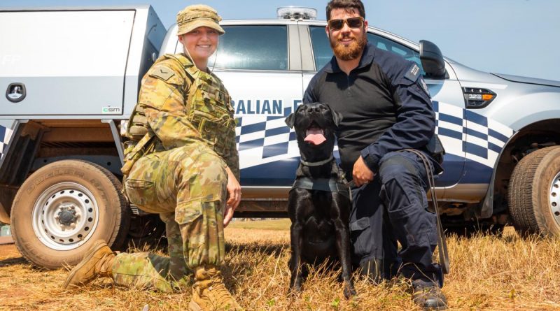 Royal Australian Air Force military working dog handler Leading Aircraftwoman Taylah Cole greets an Australian Federal Police working dog and her handler at RAAF Base Darwin. Story by Flight Lieutenant Dee Irwin. Photo by Leading Aircraftman Sam Price.