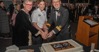 Mayor of the City of Shoalhaven Amanda Findley, left, Maritime Logistics Personnel Leading Seaman Stephanie Hart and Commander Fleet Air Arm Commodore David Frost, cut a cake to celebrate the 75th anniversary of the FAA. Story by Lieutenant Brendan Trembath. Photo by Leading Seaman Ryan Tascas.