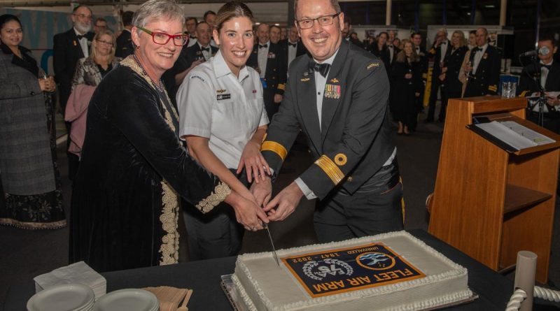 Mayor of the City of Shoalhaven Amanda Findley, left, Maritime Logistics Personnel Leading Seaman Stephanie Hart and Commander Fleet Air Arm Commodore David Frost, cut a cake to celebrate the 75th anniversary of the FAA. Story by Lieutenant Brendan Trembath. Photo by Leading Seaman Ryan Tascas.