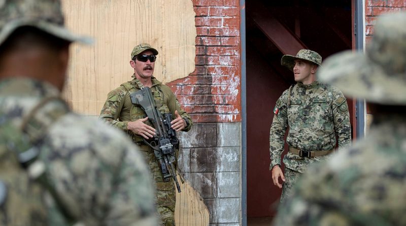 Private Lucas Hinselwood from 1st Battalion, the Royal Australian Regiment briefs marines from the Mexican Naval Infantry during Urban Close Combat training on RIMPAC 2022. Story by Flying Officer Lily Lancaster. Photo by Corporal John Solomon.