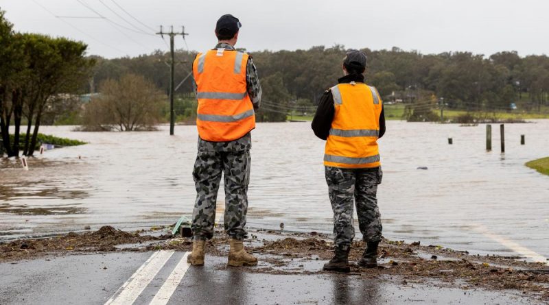 Royal Australian Navy Midshipman Daniel Snels and Able Seaman Alice Shelverton from Joint Task Force 629 assess the Hawkesbury River flooding in Pitt Town, NSW. Photo by David Cotton.