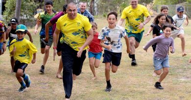 Indigenous Advisory Committee members Patrick Johnson, left, and Kyle Vander-Kuyp are joined by Air Mobility Group Warrant Officer Stephen Weaver, centre, in a race with local kids on Thursday Island. Story by Flight Lieutenant Suellen Heath. Photo by Leading Aircraftwoman Kate Czerny.