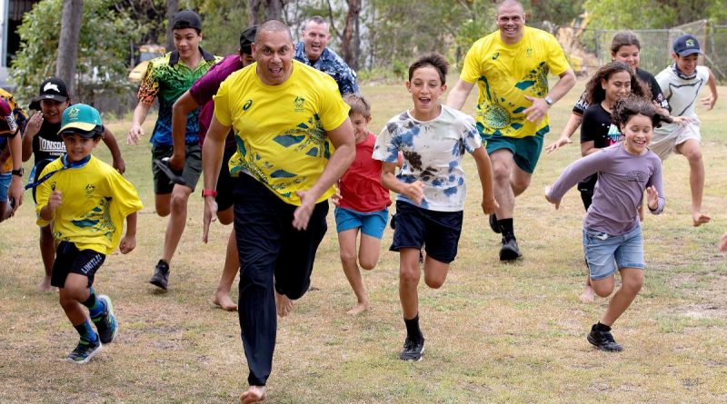 Indigenous Advisory Committee members Patrick Johnson, left, and Kyle Vander-Kuyp are joined by Air Mobility Group Warrant Officer Stephen Weaver, centre, in a race with local kids on Thursday Island. Story by Flight Lieutenant Suellen Heath. Photo by Leading Aircraftwoman Kate Czerny.