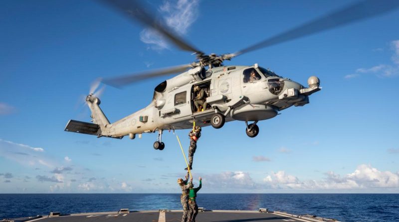 A Royal Australian Navy MH-60R Seahawk helicopter winches Commanding Officer HMAS Parramatta Commander David Murphy onto the flight deck during their regional presence deployment. Story by Lieutenant Carolyn Martin and Lieutenant Commander Andrew Herring. Photo by Leading Seaman Leo Baumgartner.