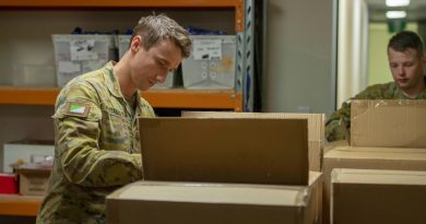 Two members from 7th Brigade labelling which of the many Legacy bears they're packing, with options ranging from Army to Navy to Royal Australian Air Force. Story and photo by Captain Cody Tsaousis.