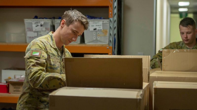 Two members from 7th Brigade labelling which of the many Legacy bears they're packing, with options ranging from Army to Navy to Royal Australian Air Force. Story and photo by Captain Cody Tsaousis.