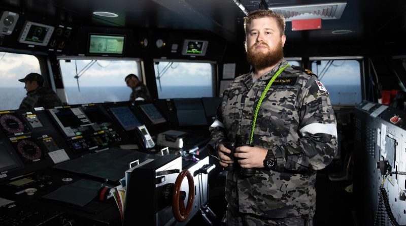 Sub Lieutenant Thomas Watson keeps watch on the bridge of HMAS Canberra during Exercise RIMPAC 2022. Story by Lieutenant Nancy Cotton. Photo by Leading Seaman Matthew Lyall.
