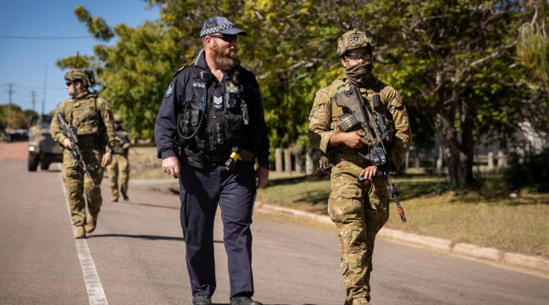 Soldiers from the 3rd Battalion, Royal Australian Regiment, and Queensland Police Service Officer Tony Hoise patrol through Charters Towers in Queensland, during Exercise Brolga Run 2022. Story by Major Megan McDermott. Photo by Gunner Gregory Scott.