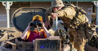 A soldier from 3rd Battalion, Royal Australian Regiment interacts with a Charters Towers local at the at the Exercise Brolga Run 2022 community open day. CAPTION: Captain Diana Jennings. Photo by Gunner Gregory Scott.