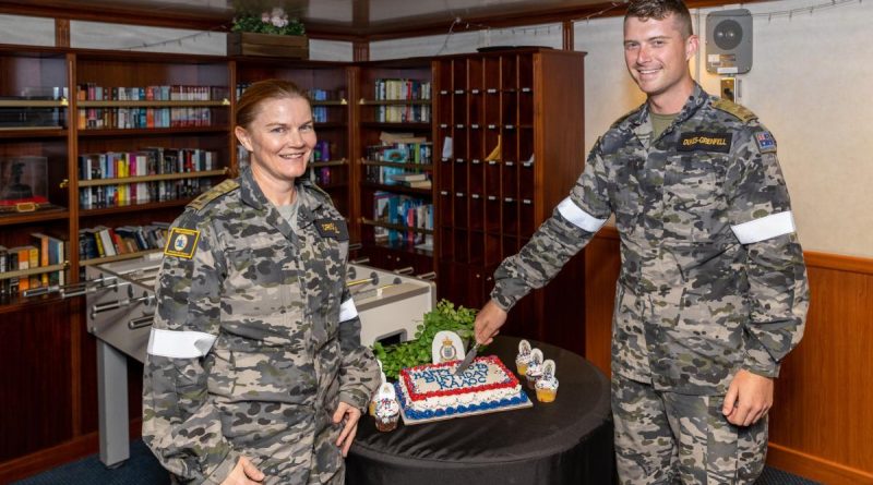 Major Raechel Driscoll and Private Caylun Dukes-Grenfell cut a cake to commemorate the 120th birthday of the Royal Australian Army Ordnance Corps on board HMAS Canberra during Exercise Rim of the Pacific 2022. Photo by Leading Seaman Matthew Lyall.