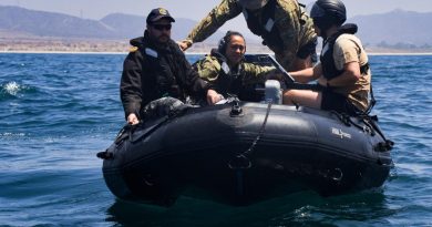 Multinational training participants prepare to launch a REMUS 100 autonomous underwater vehicle (AUV) as a part of an AUV and unmanned underwater vehicles search and calibration training event conducted during RIMPAC 2022. Photo by Seaman Victoria Danser.