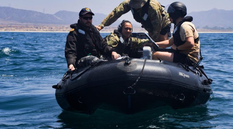 Multinational training participants prepare to launch a REMUS 100 autonomous underwater vehicle (AUV) as a part of an AUV and unmanned underwater vehicles search and calibration training event conducted during RIMPAC 2022. Photo by Seaman Victoria Danser.