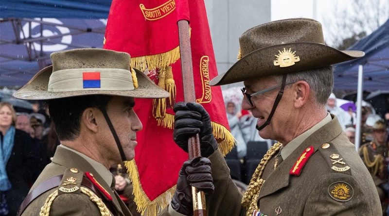 The Army Banner is handed from outgoing Chief of Army Lieutenant General Rick Burr, right, to incoming Chief of Army Lieutenant General Simon Stuart during the Chief of Army handover parade. Photo by Kym Smith.