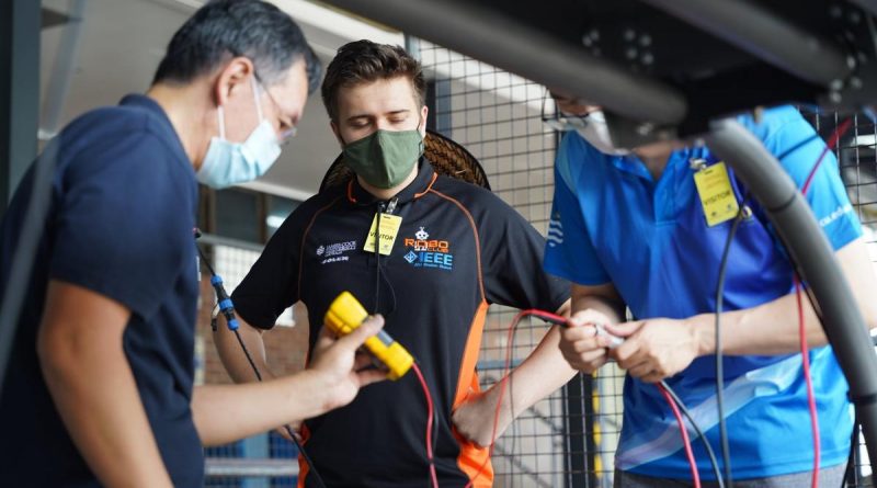 The James Cook University team work on their autonomous vehicle for the RobotX competition in November. Story by Edwina Callus. Photo Supplied.