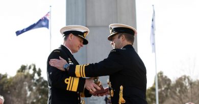 Vice Admiral Michael Noonan presents the "weight" of command to Vice Admiral Mark Hammond during the Chief of Navy Change of Command Ceremony. Photo by Leading Seaman Tara Morrison.