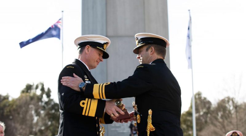 Vice Admiral Michael Noonan presents the "weight" of command to Vice Admiral Mark Hammond during the Chief of Navy Change of Command Ceremony. Photo by Leading Seaman Tara Morrison.