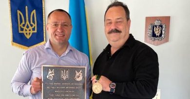 Ukraine's Ambassador to Australian Myroshnychenko Vasyl receives a plaque and medallion honouring Ukraine's war-affected animal population from Australian War Animals Memorial Organisation president Nigel Allsopp. Photos supplied.