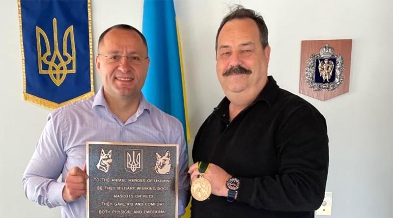 Ukraine's Ambassador to Australian Myroshnychenko Vasyl receives a plaque and medallion honouring Ukraine's war-affected animal population from Australian War Animals Memorial Organisation president Nigel Allsopp. Photos supplied.