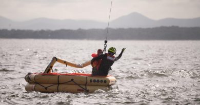 A member of Air Force's No. 2 Squadron is winched from a life raft on Nelson Bay to a search and rescue helicopter during a survival training exercise. Story by Flight Lieutenant Claire Burnet. Photo by Lieutenant Samuel Hicks.