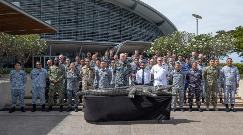 Exercise Kakadu Final Planning Conference delegates gather outside Darwin Convention Centre accompanied by the adopted exercise mascot, a 4-metre-long wooden crocodile nicknamed 'Fluffy'. Story by Lieutenant Commander Andrew Herring. Photo by Sergeant Pete Gammie.