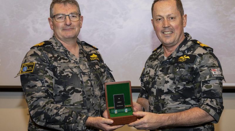 Commander Fleet Air Arm Commodore David Frost, right, presents Lieutenant Ian Donovan with the Federation Star for 40 years of service at a presentation ceremony at HMAS Albatross. Story by Lieutenant Danielle Worthey. Photo: Petty Officer Justin Brown.