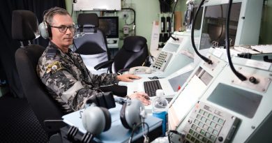 Flight Lieutenant Allister Daish mans the air traffic control console in the air traffic control room on board HMAS Canberra during Exercise Rim of the Pacific (RIMPAC) 2022. Story by Lieutenant Nancy Cotton. Photo by Leading Seaman Matthew Lyall.