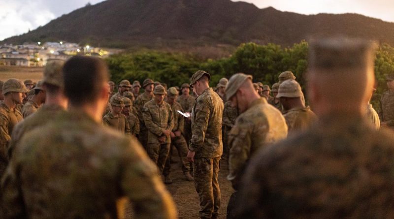 Captain David Wohlgemuth from the 2nd Battalion, Royal Australian Regiment reads the soldiers a prayer at a memorial service for the 69th anniversary of the Battle of Samichon at Marine Corps Base Hawaii. Story by Flying Officer Lily Lancaster. Photo by Leading Seaman Jarrod Mulvihill.