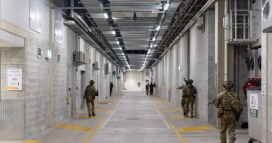 Members of the ADF and Queensland Police Service clear the lower levels of the Queensland Country Bank Stadium as part of Exercise Austral Shield 2022 in Townsville. Lieutenant Geoff Long. Photo by Corporal Jonathan Goedhart.