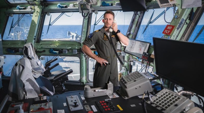 Lieutenant Samuel Laidlaw controls air traffic from the flight bridge on board HMAS Canberra during Exercise Rim of the Pacific (RIMPAC) 2022. Story by Lieutenant Nancy Cotton. Photo by Leading Seaman Matthew Lyall.
