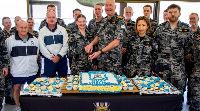 Commanding Officer HMAS Stirling Captain Gary Lawton cuts HMAS Stirling's birthday cake with the bases youngest member Seaman Amity Coyer. Story by Lieutenant Gary McHugh. Photo by Lieutenant Gary McHugh.