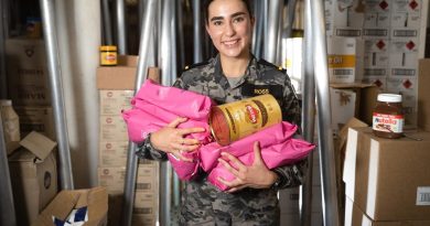 Maritime Logistics Officer Sub-Lieutenant Amelia Ross holds an assortment of coffee products in the dry store of HMAS Canberra during Exercise Rim of the Pacific (RIMPAC) 2022 in the Pacific Ocean. Story by Lieutenant Nancy Cotton. Photo by Leading Seaman Matthew Lyall.