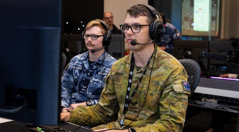 Corporal Jackson Smart, right, takes part in the space training exercise with Air Force air surveillance operator Leading Aircraftman Jasper Gleadhill at the Australian Space Discovery Centre. Story by Sergeant Matthew Bickerton. Photo by Leading Aircraftwoman Annika Smit.